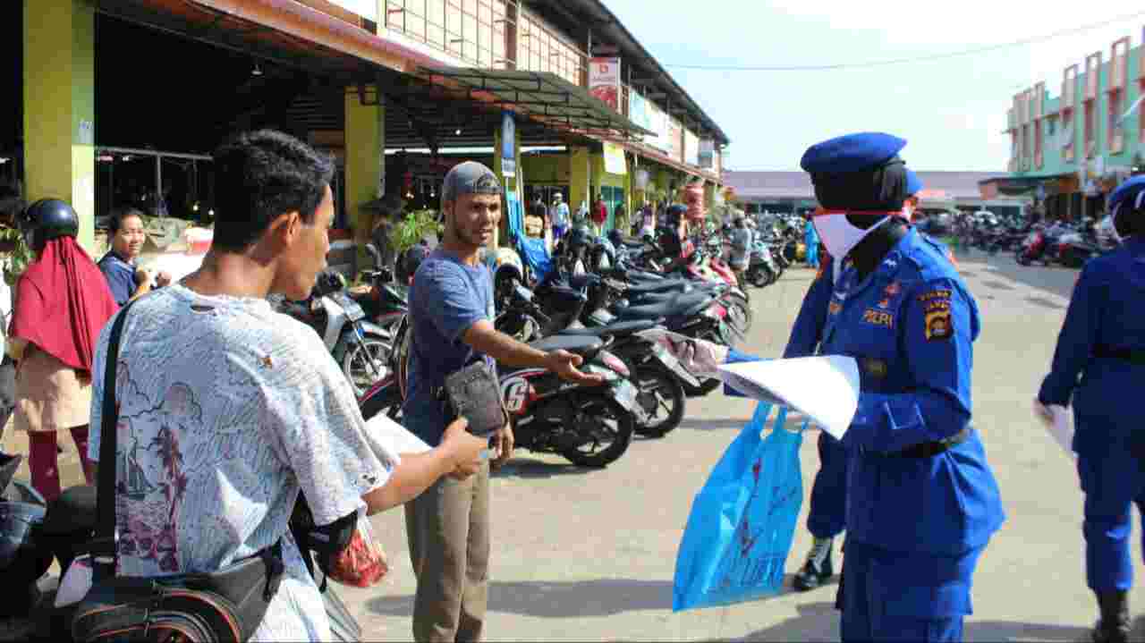 Anggota Ditpolairud Polda Jambi saat bagikan masker ke pedagang Pasar Angsoduo Baru